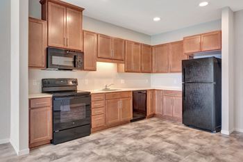 A kitchen with wooden cabinets and black appliances