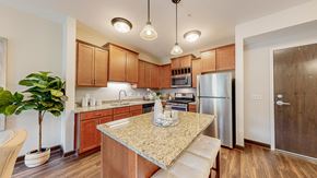 Victoria apartment for rent - a kitchen with a granite counter top and a stainless steel refrigerator at Victoria Flats, Victoria, 55386