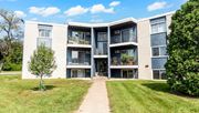 Fridley apartment for rent - A large apartment complex with a walkway in front.