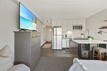Bloomington apartment for rent - a living room and kitchen with a tv on the wall