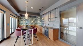 Bloomington apartment for rent - A modern kitchen with a dining table and chairs.