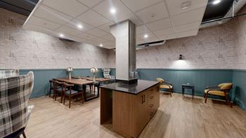 A kitchen with a wooden island and chairs.