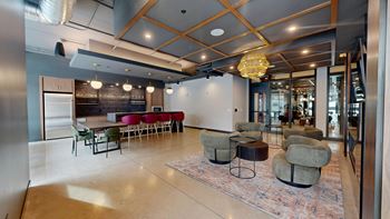 A modern room with a bar and seating area.