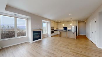 A spacious living room with a fireplace and a dining area