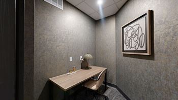 A room with a desk and a lamp.