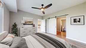 Bloomington apartment for rent - a bedroom with a bed and a ceiling fan at Ardor on the Bluffs South Loop Residences Apartments, Bloomington, 55425