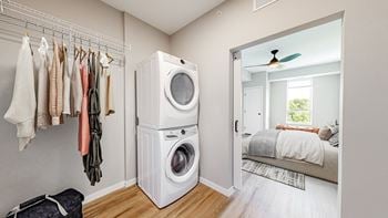 A laundry room with a washer and dryer stacked on top of each other