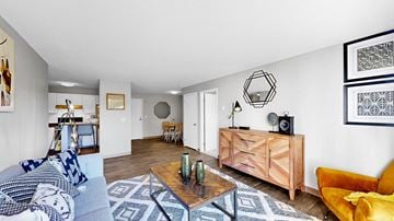 Bloomington apartment for rent - A living room with a yellow chair and a wooden coffee table.