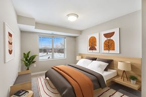 Inver Grove Heights apartment for rent - a bedroom with a bed and paintings on the wall