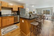 Inver Grove Heights apartment for rent - a kitchen with a large island with bar stools and a dining table