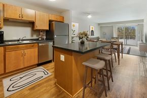 Inver Grove Heights apartment for rent - a kitchen with a large island with bar stools and a dining table