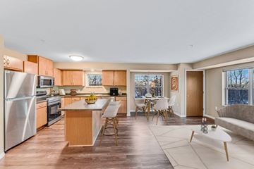 Inver Grove Heights apartment for rent - a living room with a kitchen and a table with chairs