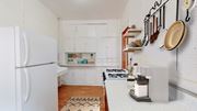 Minneapolis apartment for rent - a kitchen with white cabinets and a white refrigerator