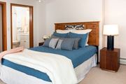 Mahtomedi apartment for rent - a bedroom with a bed and a nightstand  at Briarcliff Apartments, a 55+ Community, Mahtomedi, Minnesota