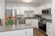 Mahtomedi apartment for rent - a kitchen with white cabinets and gray countertops  at Briarcliff Apartments, a 55+ Community, Mahtomedi