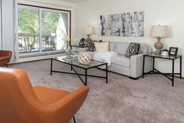 Burnsville apartment for rent - a living room with a couch and a table and a window