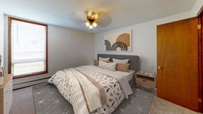 Bloomington apartment for rent - a bedroom with a large bed and a window