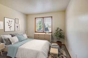 Bloomington apartment for rent - a bedroom with a large bed and a window