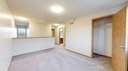 Minnetonka townhouse for rent - A spacious room with a carpeted floor and a sliding glass door.