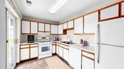 Eagan apartment for rent - A kitchen with white cabinets and a white refrigerator.