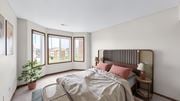 Eagan apartment for rent - A bedroom with a large bed and a potted plant.