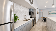 Eagan apartment for rent - A modern kitchen with a stainless steel refrigerator and a marble backsplash.