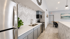 Eagan apartment for rent - A modern kitchen with a stainless steel refrigerator and a marble backsplash.