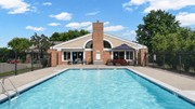 Eagan apartment for rent - A pool in front of a house with a black fence.