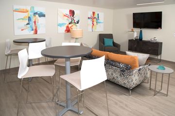 New Hope apartment for rent - A living room with a grey table surrounded by white chairs.