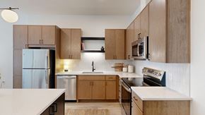 Rosemount apartment for rent - A modern kitchen with wooden cabinets and stainless steel appliances.