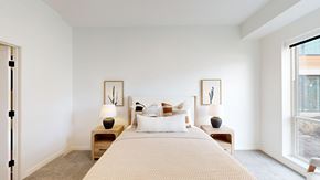 Rosemount apartment for rent - A bedroom with a large bed and two nightstands with lamps.