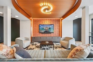 Rosemount apartment for rent - A living room with a wooden ceiling and a television mounted on the wall.