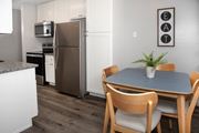 Chaska apartment for rent - kitchen and dining with new white cabinetry, granite countertops, stainless steel appliances