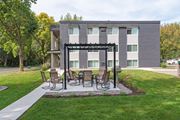 Chaska apartment for rent - a patio with a table and chairs in front of a building