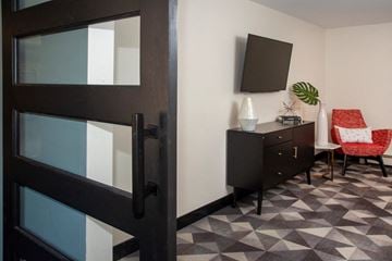 Eagan apartment for rent - a living room with a desk and a chair and a television