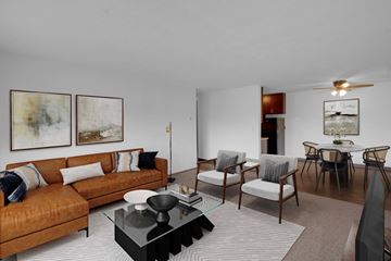 Brooklyn Center apartment for rent - a living room with a couch and chairs and a dining room table