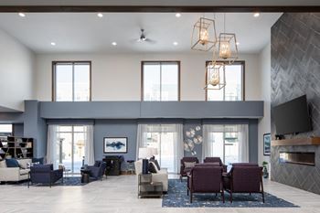 A modern living room with a grey sofa set and a fireplace.