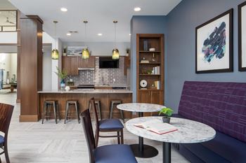A modern kitchen with a bar area and seating.