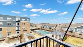 Lakeville apartment for rent - A view from a balcony overlooking a pool and apartment buildings.