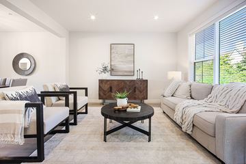 Lakeville townhouse for rent - A living room with a grey couch, a coffee table, and a painting on the wall.