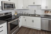 Inver Grove Heights apartment for rent - a kitchen with white cabinets and stainless steel appliances