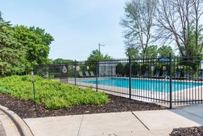 Inver Grove Heights apartment for rent - a swimming pool with a black fence in front of it
