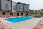 Saint Paul apartment for rent - a swimming pool with chaise lounge chairs and a building in the background