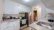 Fridley apartment for rent - A kitchen with white cabinets and stainless steel appliances.