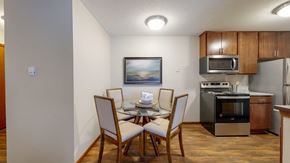 New Brighton apartment for rent - a dining area with a table and chairs and a kitchen in the background