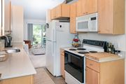 Eden Prairie apartment for rent - a kitchen with wooden cabinets and white appliances