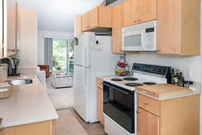 Eden Prairie apartment for rent - a kitchen with wooden cabinets and white appliances