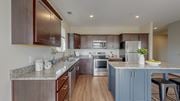 Chaska apartment for rent - A kitchen with brown cabinets and a granite countertop. at Lake Jonathan Flats, Minnesota, 55318
