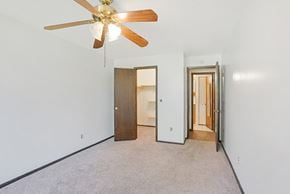 Saint Paul apartment for rent - a bedroom with a ceiling fan and a door to a bathroom