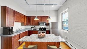 Minneapolis apartment for rent - A kitchen with wooden cabinets and a granite countertop.